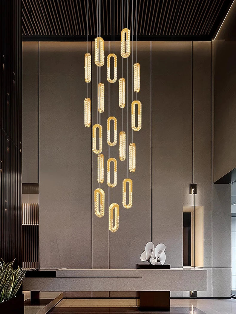 Modern chandelier hanging in a stylish interior setting with a neutral color palette.