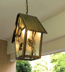Decorative outdoor pendant light with a house-shaped design, hanging from a ceiling.