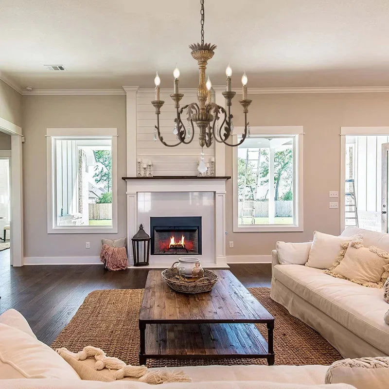 Living room with a fireplace, chandelier, and comfortable furniture.