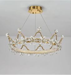 Gold chandelier with crystal accents on a gray background