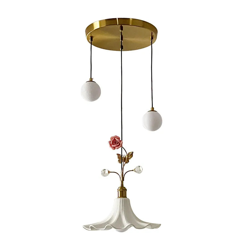 Close-up of the gold floral rose bud ceramic pendant light against a white background