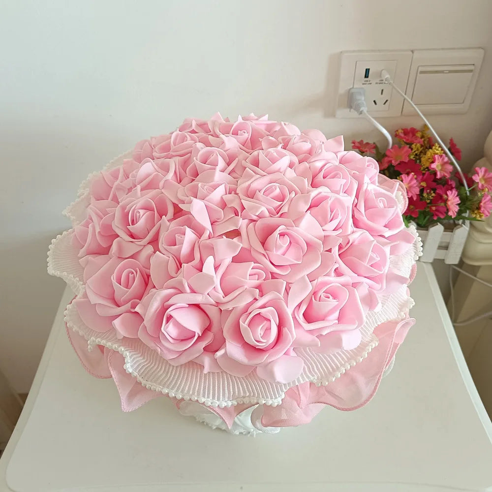 Large bouquet of pink roses on a white surface with a light background