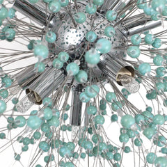Close-up of a decorative ceiling light fixture with turquoise beads and chrome finish.