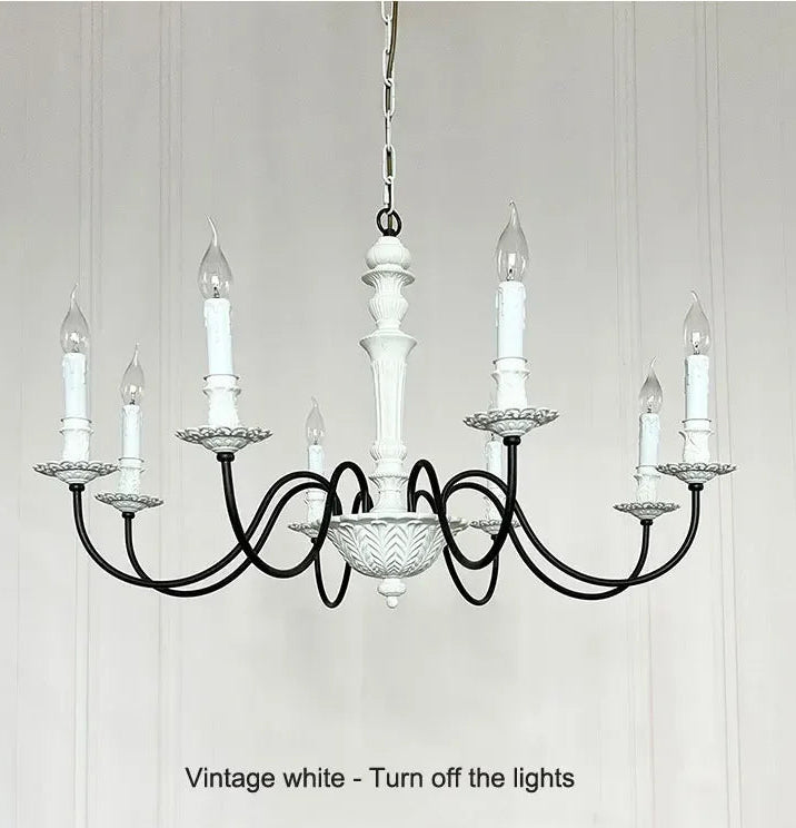 Vintage-style chandelier with white candles on a light gray background