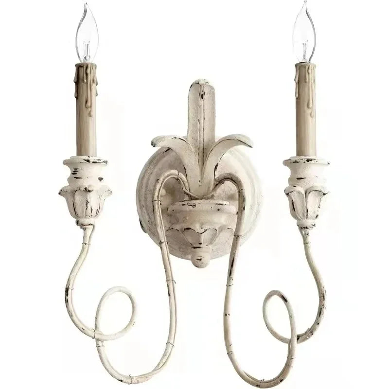 Decorative wall sconce with two candles on a white background