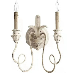 Decorative wall sconce with two candles on a white background