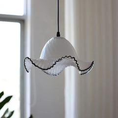 White pendant light with black rim against a neutral background