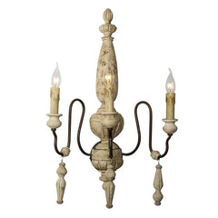Decorative wall sconce with three candle-style lights on a white background
