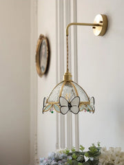 Wall-mounted lamp with butterfly design on a neutral wall background