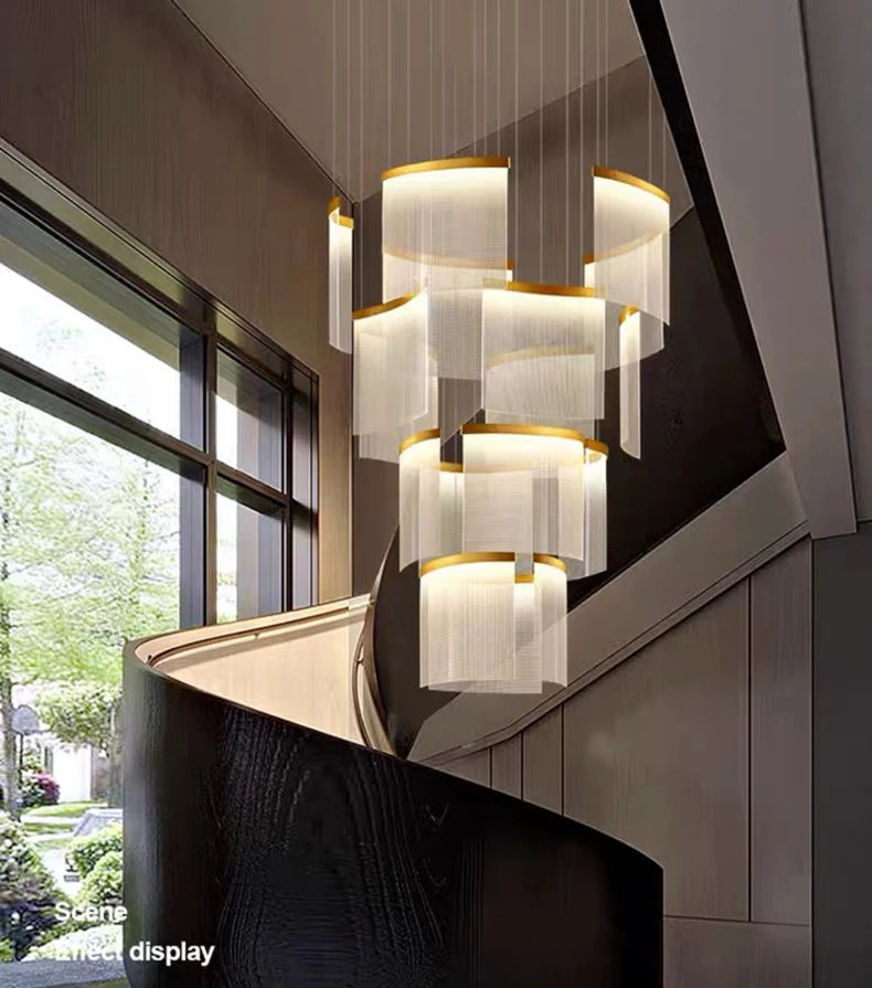 Modern chandelier hanging in a room with large windows