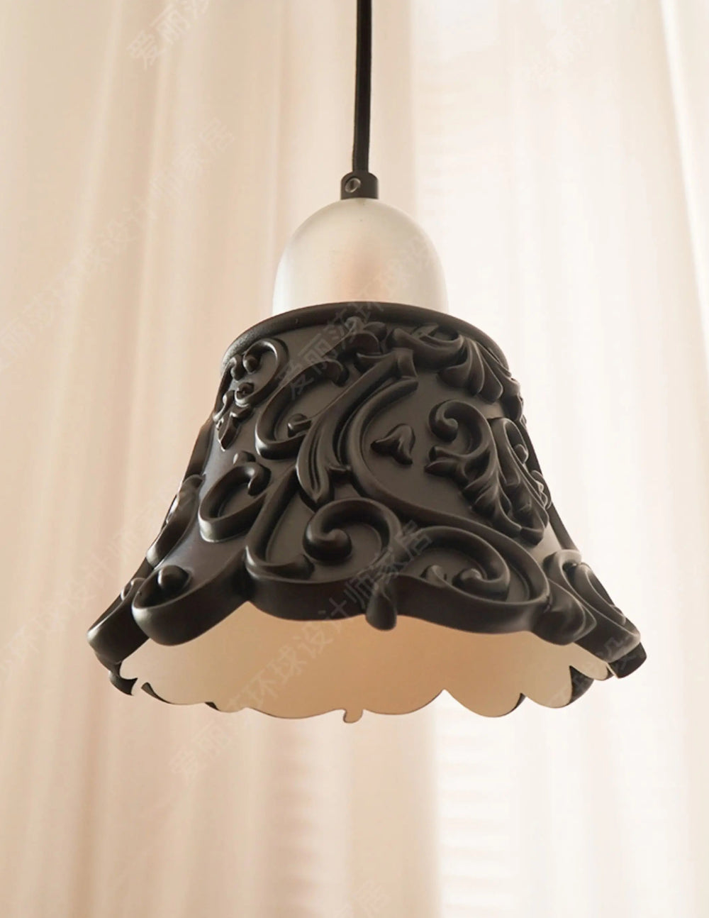 Decorative pendant light with intricate design on a plain background