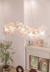 Modern chandelier hanging in a room with decor elements.