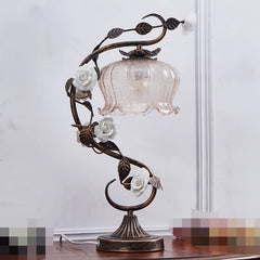Decorative table lamp with floral design on a plain background