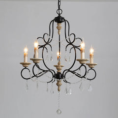 Close-up of the black iron chandelier's central column adorned with wood beads and decorative elements.
