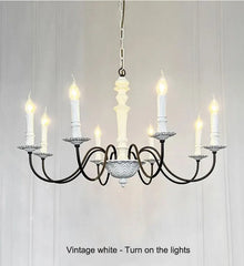 Vintage-style chandelier with multiple candle-like lights on a white background