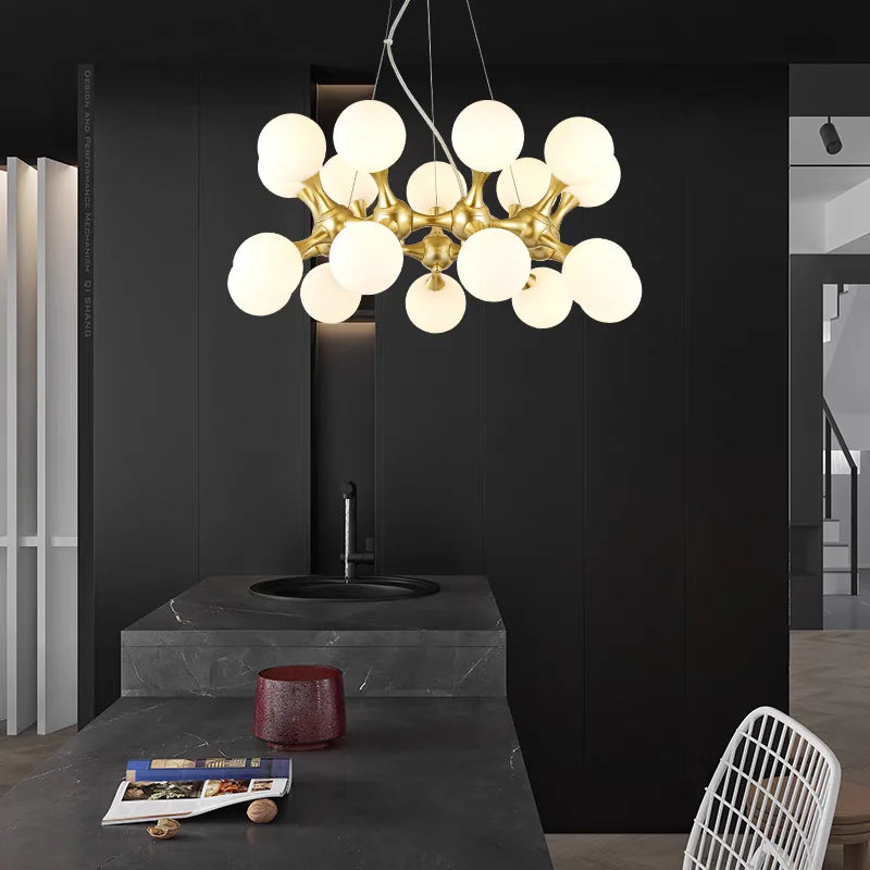 Modern chandelier with spherical lights in a minimalistic interior setting.