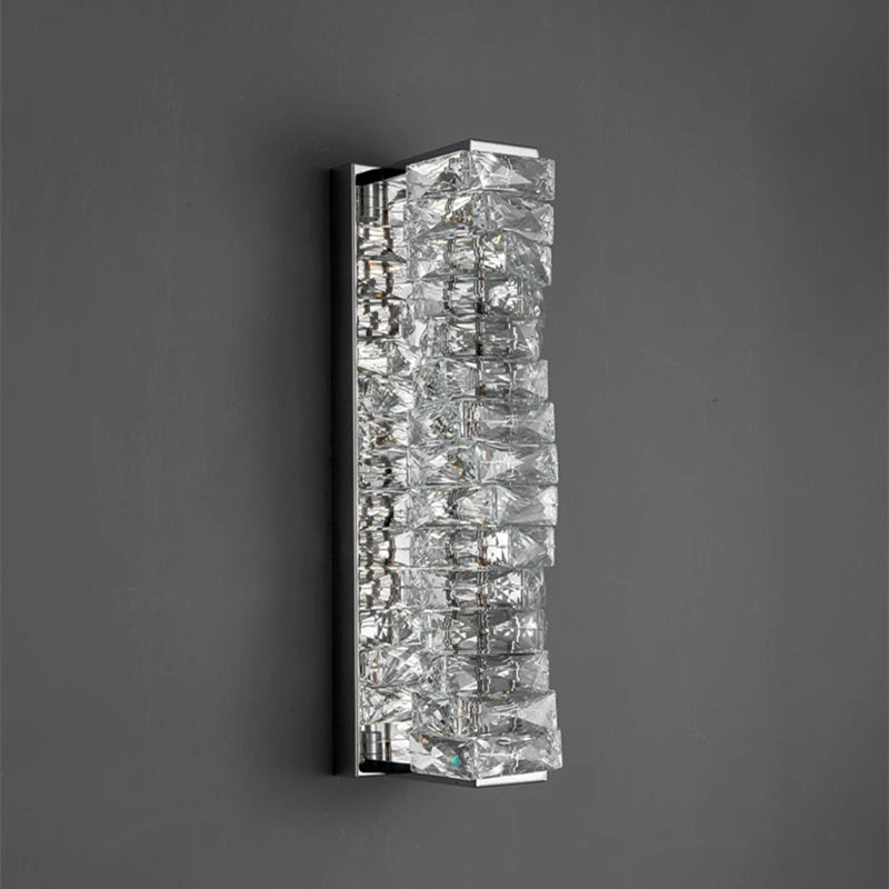 Wall-mounted light fixture with crystal-like design on a dark background