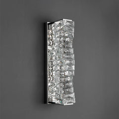 Wall-mounted light fixture with crystal-like design on a dark background
