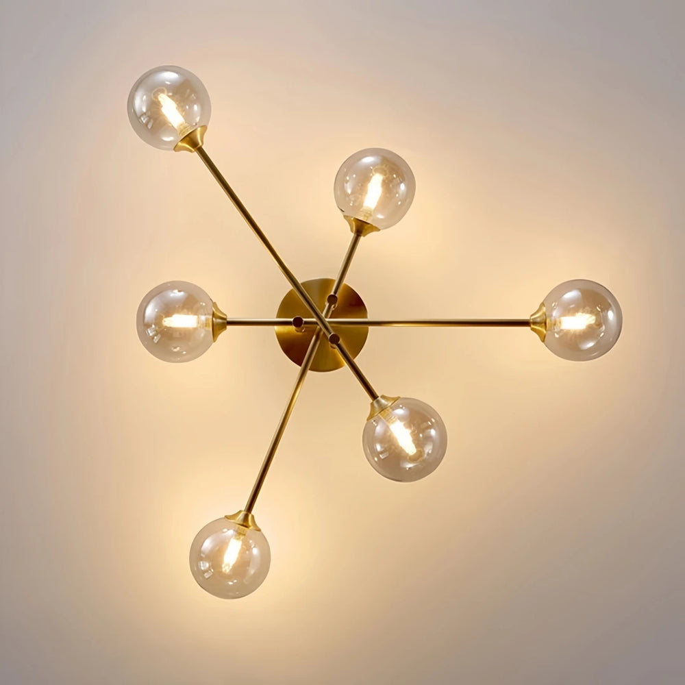 Gold sputnik starburst semi-flush ceiling light close-up showing glass globes and central fixture
