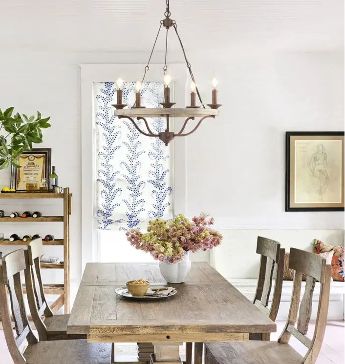 Dining room with wooden table, chairs, and decorative elements.