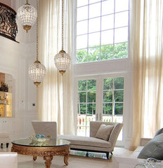 Living room with chandelier, sofa, and large windows