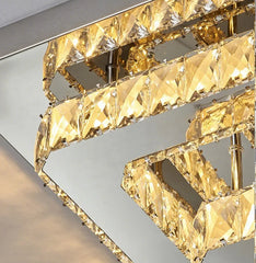 Gold chandelier with crystal-like design on a neutral background