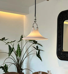 Dining area with a wooden table, chairs, and a large mirror on the wall.