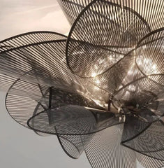 Decorative ceiling light fixture with intricate design on a neutral background