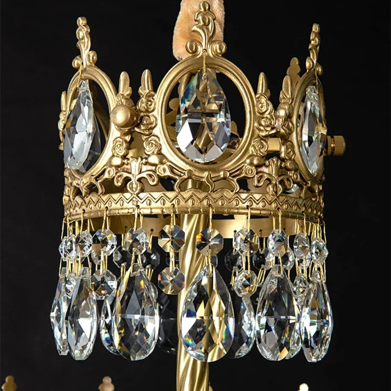 Decorative gold crown with crystal elements on a black background