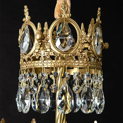 Decorative gold crown with crystal elements on a black background