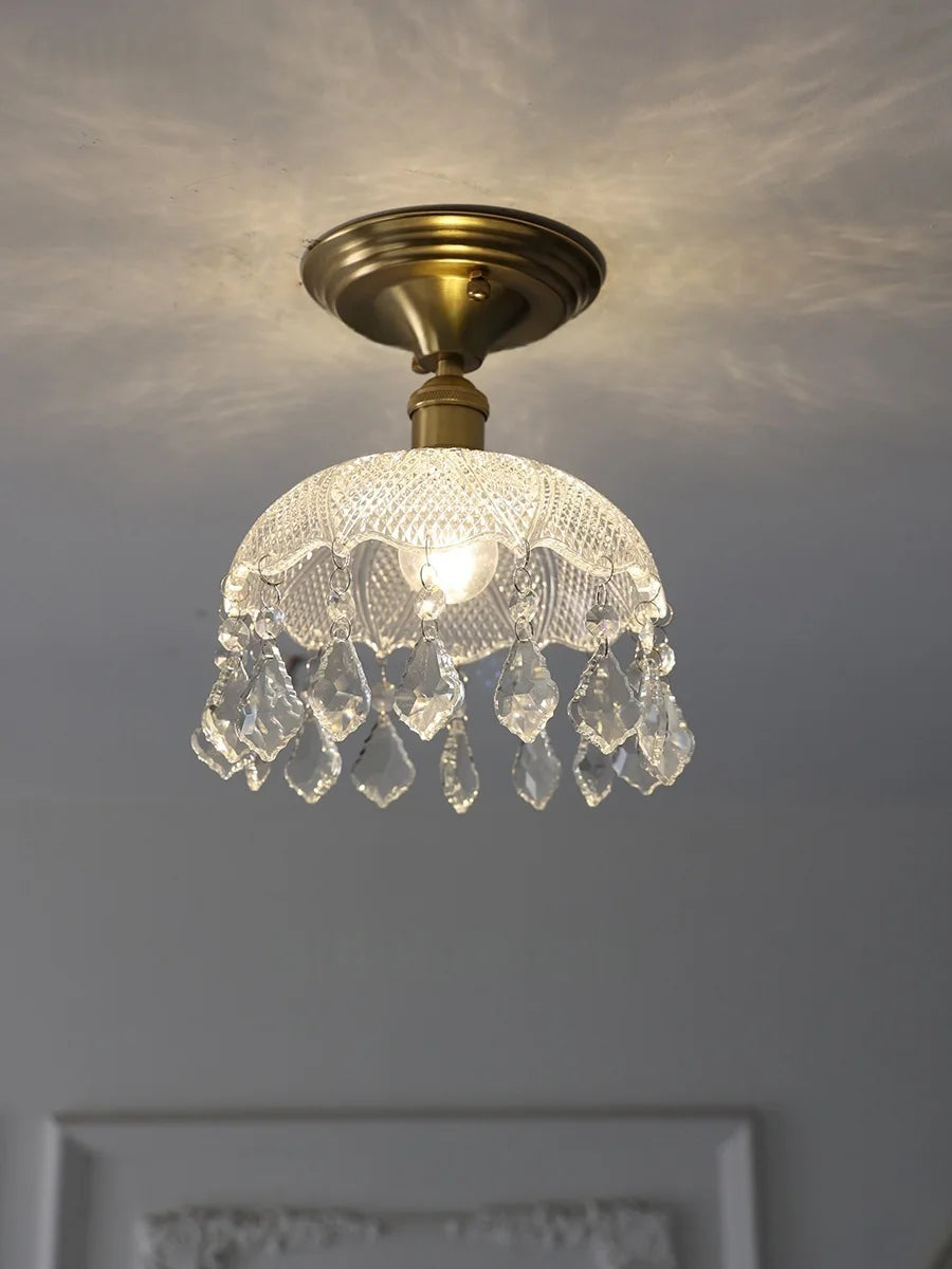 Ceiling light fixture with crystal shade on a neutral background