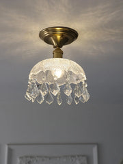 Ceiling light fixture with crystal shade on a neutral background