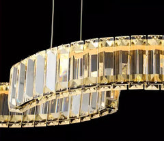 Gold chandelier with clear crystals against a black background