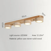 Linear ceiling light with four cylindrical travertine stone shades mounted on a natural wood base, showing dimensions 65cm, 6.5cm, and 10cm.