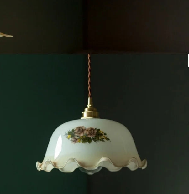 Decorative pendant light with floral design on a dark background