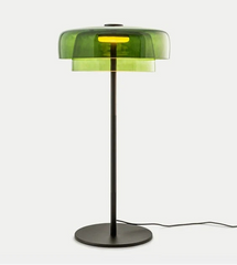 Modern floor lamp with green transparent shade on a white background