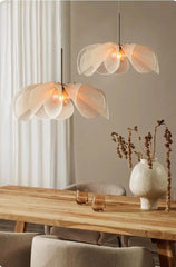 Modern pendant lights hanging above a wooden table with decorative items.