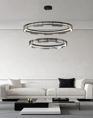 Modern living room with a white sofa and stylish ceiling lights.