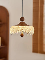 Wooden pendant light with crystal accents in a room setting
