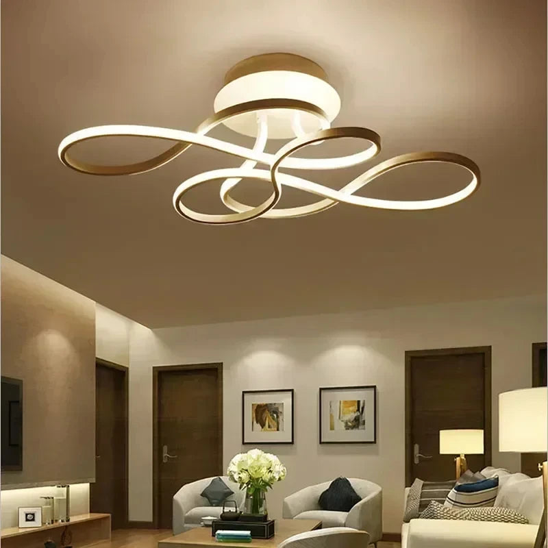 Living room interior with a gold swirl flush mount ceiling light providing ambient illumination.