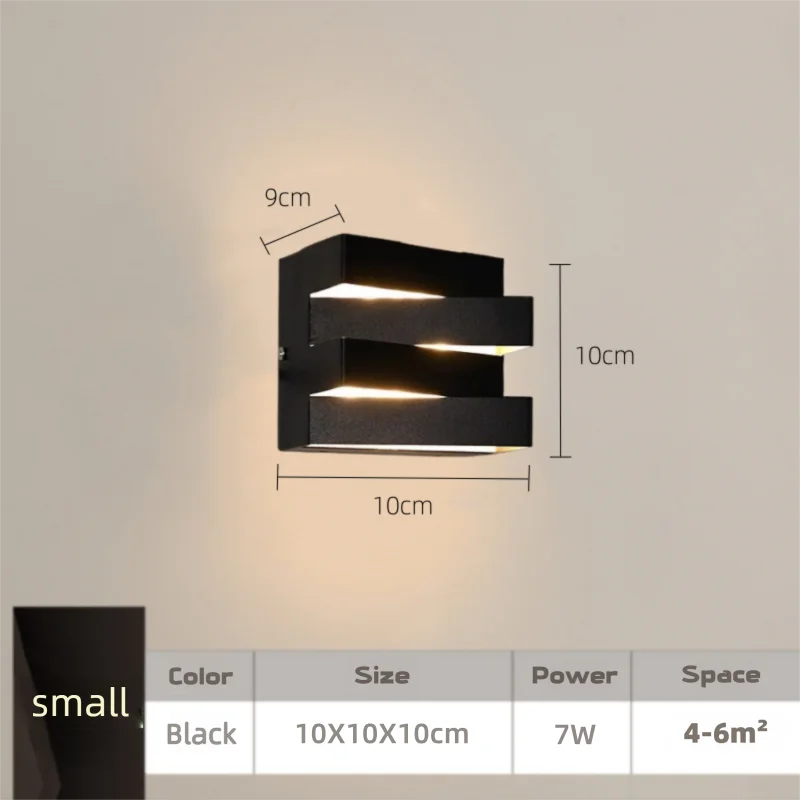 Black wall light fixture with dimensions on a neutral background