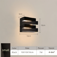 Black wall light fixture with dimensions on a neutral background