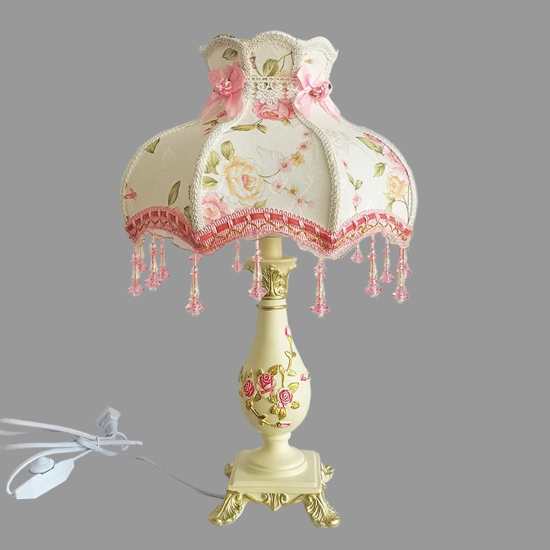 Decorative table lamp with floral design on a white background