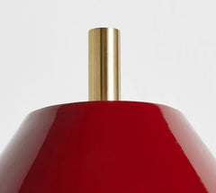 Red vase with a gold neck on a light gray background