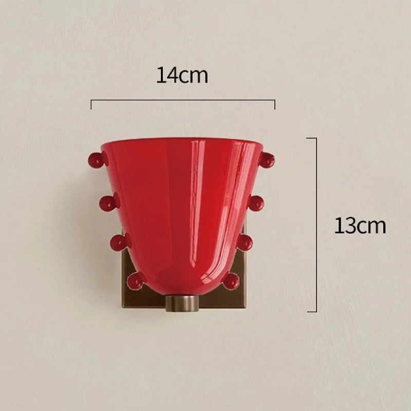 Red wall sconce with measurements on a beige background