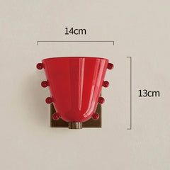 Red wall sconce with measurements on a beige background