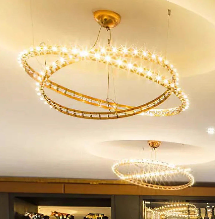 Modern chandelier hanging in a room with shelves and decor
