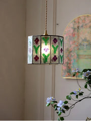 Decorative pendant light with floral design on a neutral background
