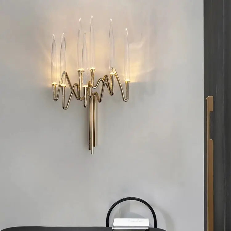 Modern wall sconce with gold finish on a gray wall