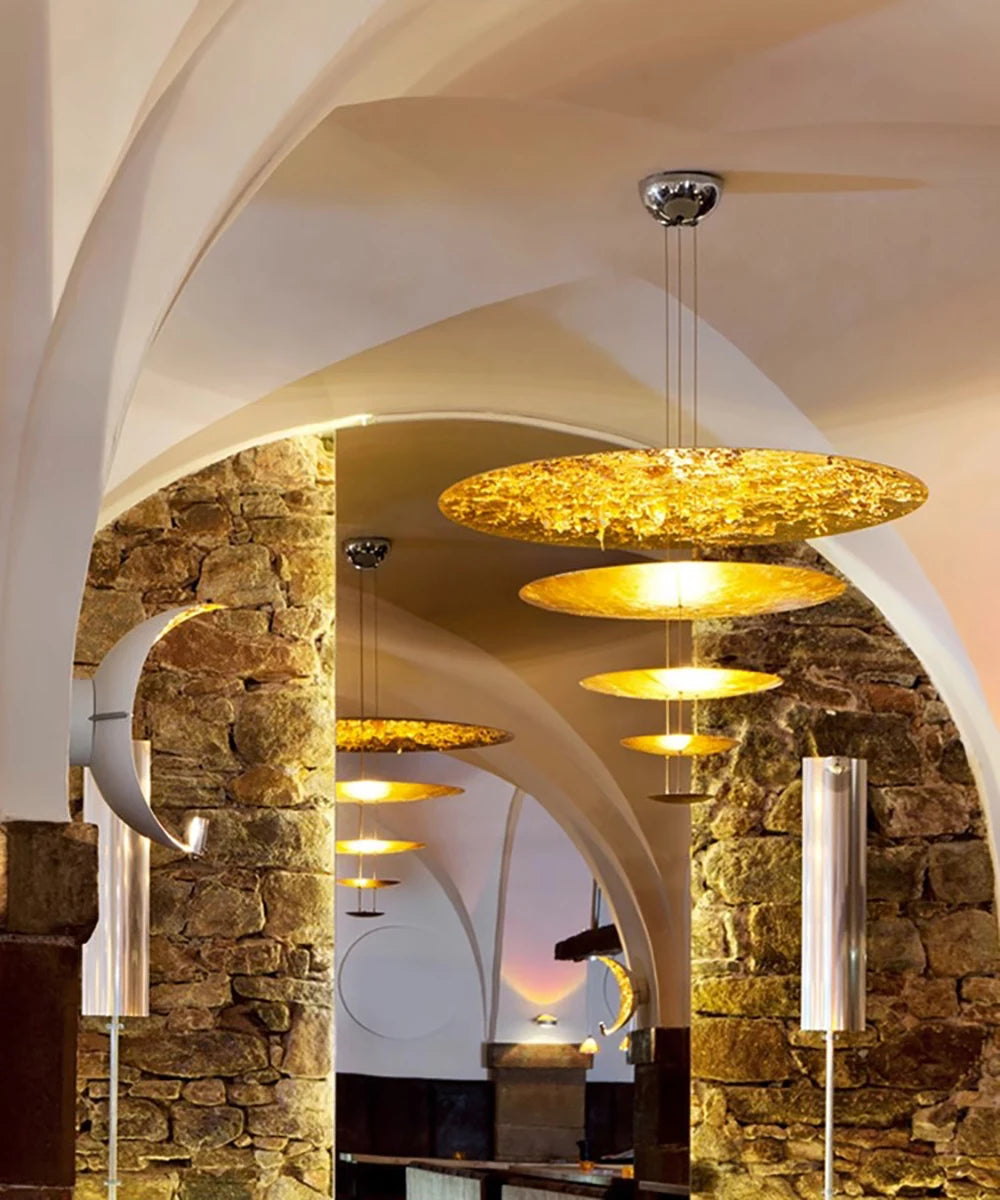 Chandelier hanging in a room with stone walls and arches